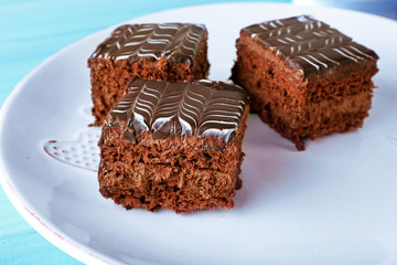 Served table with chocolate cakes on a white plate
