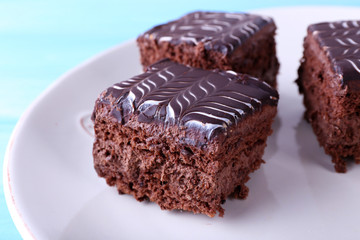 Served table with chocolate cakes on a white plate