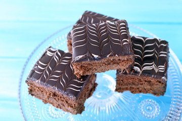 Served table with chocolate cakes on blue background close-up
