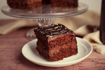 Served table with chocolate cake on wooden background