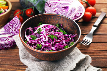 Red cabbage salad served in bowl closeup