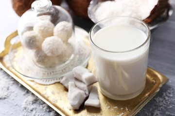 Homemade Candies in coconut flakes and fresh coconut on light background