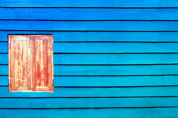 closed windows on rural blue wooden house