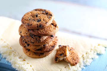 Cookies with chocolate crumbs on white napkin against blurred background, close up