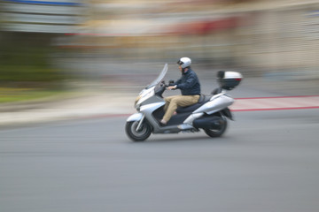 Obraz na płótnie Canvas Man riding moped in Nice, France
