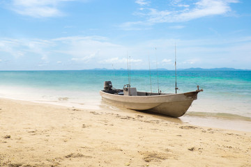Naklejka na ściany i meble Small old fishing boat on beach at Koh Chang Island.Thailand Sea
