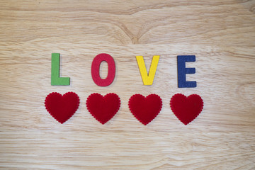 Word Love 5 - Colorful words "Love" made from wooden letters on wood background (Valentines day)