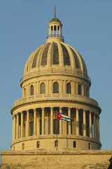 Fototapeta na wymiar Morning light on the Capitolio and Cuban Flag, the Cuban capitol building and dome in Havana, Cuba