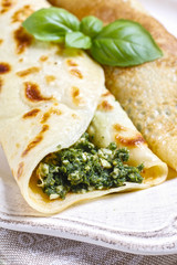 Mediterranean cuisine: crepes stuffed with cheese and spinach