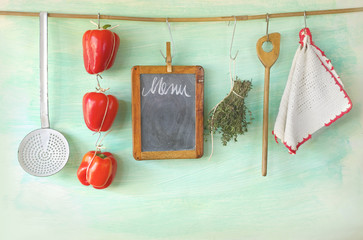 kitchen utensils, menu blackboard w. herbs and bell pepper, cook