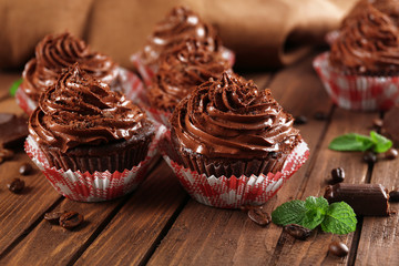 Chocolate cupcakes on wooden background closeup