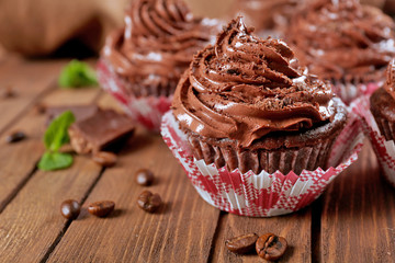 Chocolate cupcakes on wooden background closeup