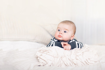 Cute baby boy with big blue eyes.