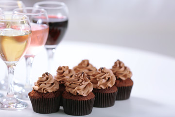 Tasting of wine and chocolate cupcakes, close up