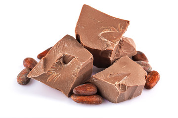 Milk chocolate pieces with cocoa beans isolated on white