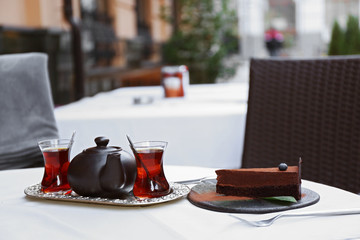 Cup of tea and cake on a table in cafe