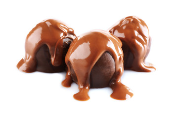 Chocolate poured on candy isolated on white