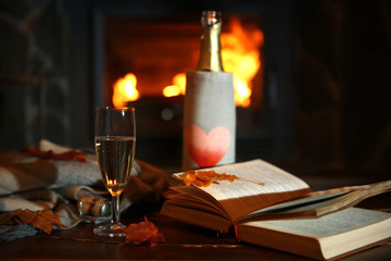 Bottle of wine on table, on fireplace background