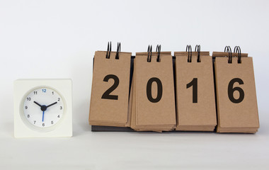 Clock and desk standing paper message new year 2016