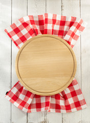 cloth napkin and cutting board on wood