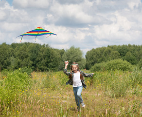little cute girl flying a kite 