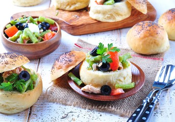homemade buns stuffed with a salad Nicoise, with green beans, olives, tomatoes, canned tuna and boiled eggs, olive oil and lemon juice.