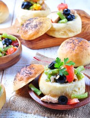 homemade buns stuffed with a salad Nicoise, with green beans, olives, tomatoes, canned tuna and boiled eggs, olive oil and lemon juice.