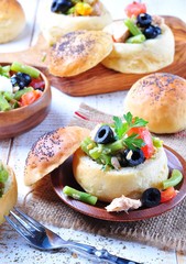 homemade buns stuffed with a salad Nicoise, with green beans, olives, tomatoes, canned tuna and boiled eggs, olive oil and lemon juice.