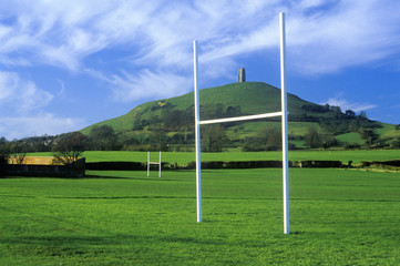 Glastonbury Tor, A sacred site along the English countryside in Glastonbury, England and goal posts in green field
