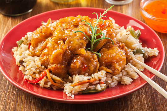 Chicken pieces with rice and sweet and sour sauce
