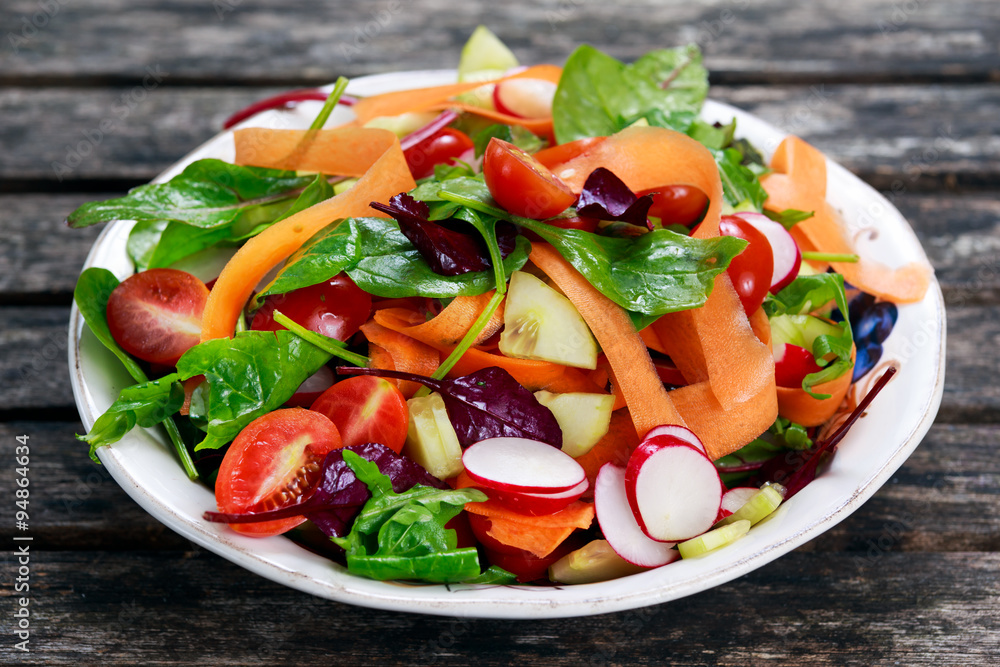 Wall mural fresh vegetable salad on old wooden table