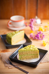 Fototapeta na wymiar Green tea cake on wood table