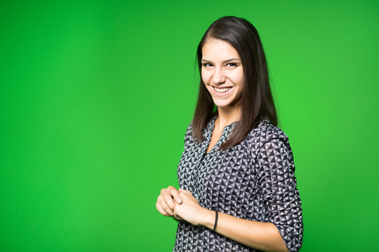 TV weather news reporter at work.News anchor presenting the world weather report.Television presenter recording in a green screen studio.Young woman with copy space on green screen chroma key