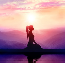 Woman meditate on mountains. Silhouette.