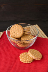 Cookies in glass cup on wooden table