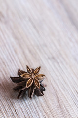 Star anise stacked over wooden background