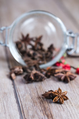 Star anise stacked over wooden background