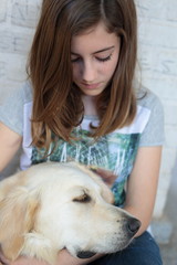 Teenage girl with her dog golden retriever