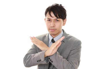 禁止の意思表示をするビジネスマン
