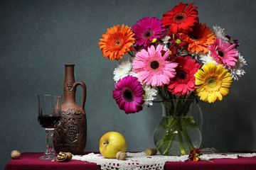 Still life with Transvaal daisies, apples and red wine. © Masquerade