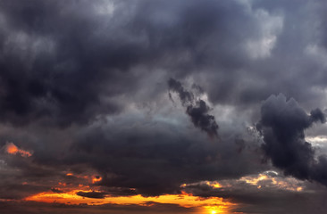 sunset, in a colorful sky with storm clouds
