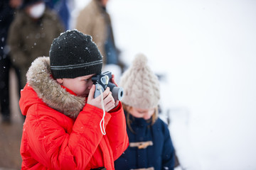 Boy taking photos on winter day