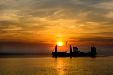 Landscape of ship sailing against sunset. Beautiful view of colo
