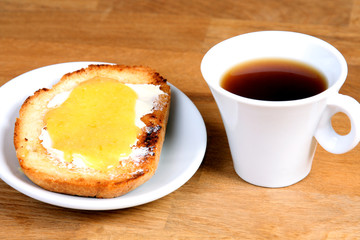 served european breakfast: cup of coffee, toasts with orange jam