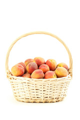 Fresh peach fruit in basket on a white background