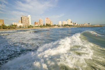 Ocean wave comes in on Durban skyline, South Africa on the Indian Ocean