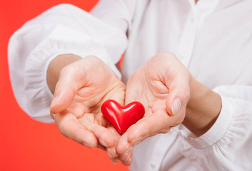 Female hand holding a ceramic heart