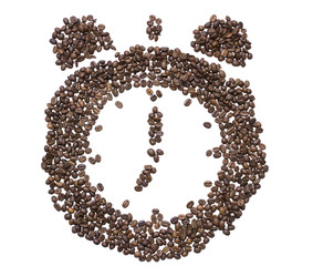 The dial of the clock with bells inlaid with roasted coffee beans showing seven in the morning or evening