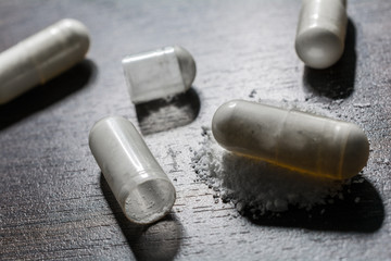 Macro Of 3 Closed And 1 Opened Medicine Capsules