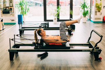 Woman on a pilates reformer